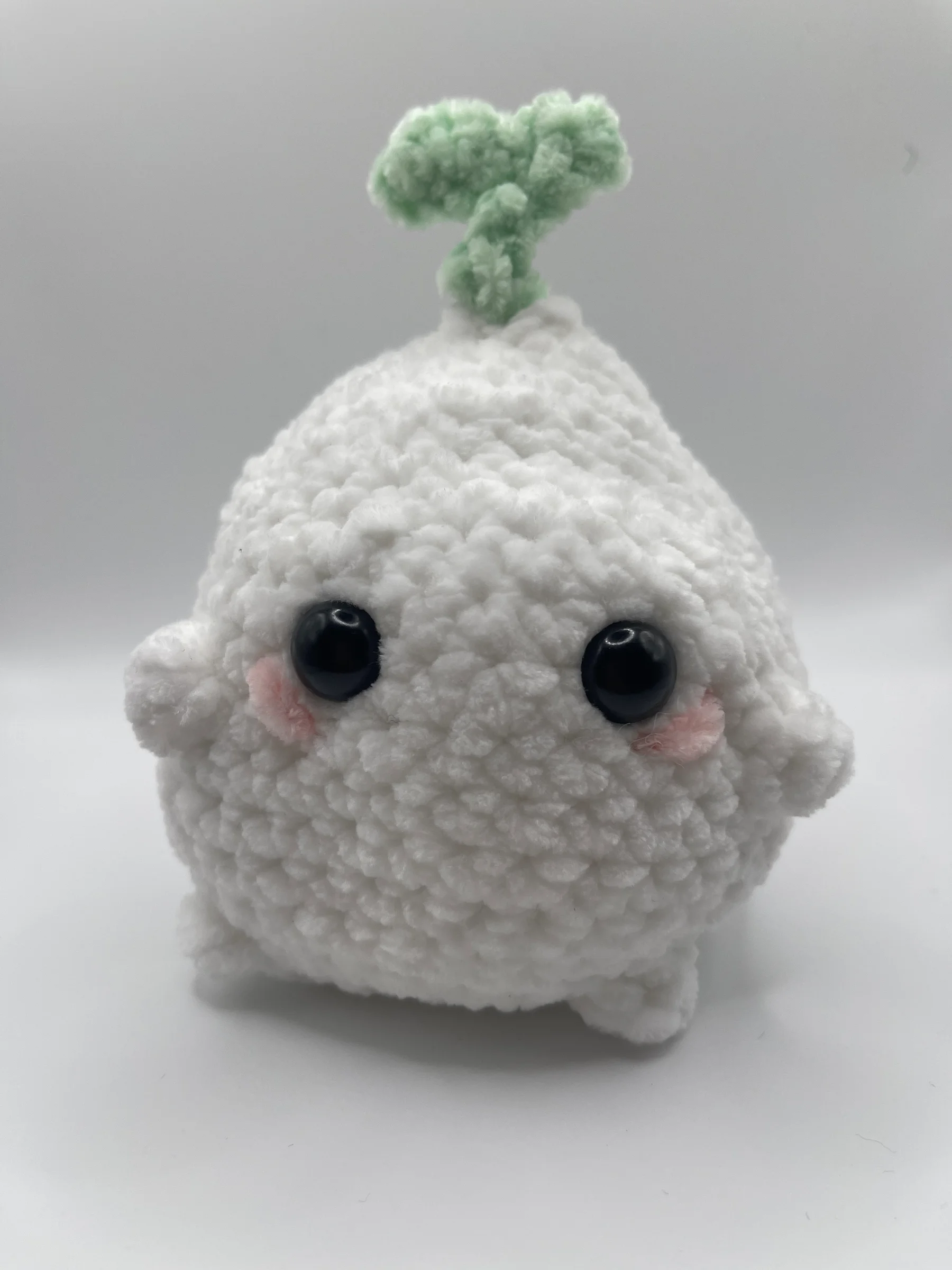 This soft adorable chubby onion features rosy chubby cheeks and a cute green sprout on top. Perfect for a desk companion or a gift!